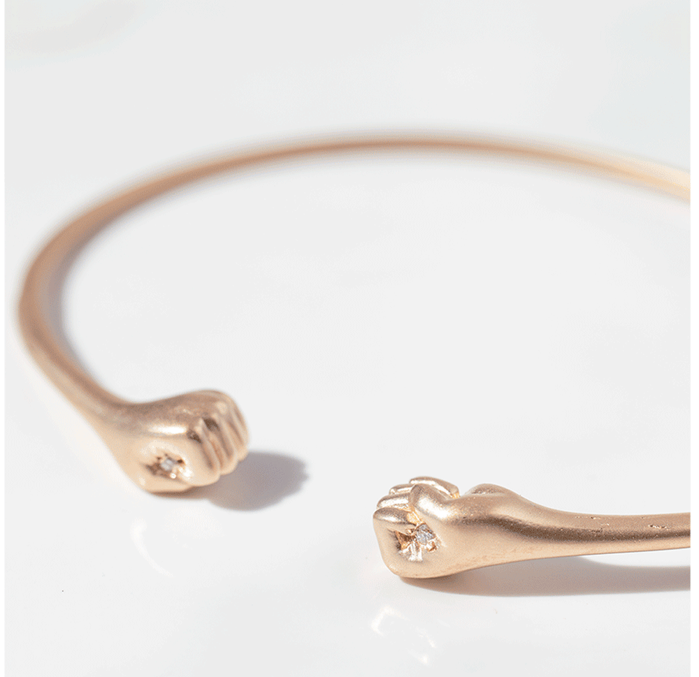 Buy a raffle ticket to support Fair Fight for a change to win this Gold diamond fist bangle by jewelry designer Victoria Cunningham