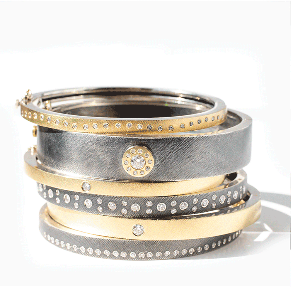 Mixed metal diamond jewelry including rings, bracelets, earrings, and necklaces, by jewelry designer Rene Escobar