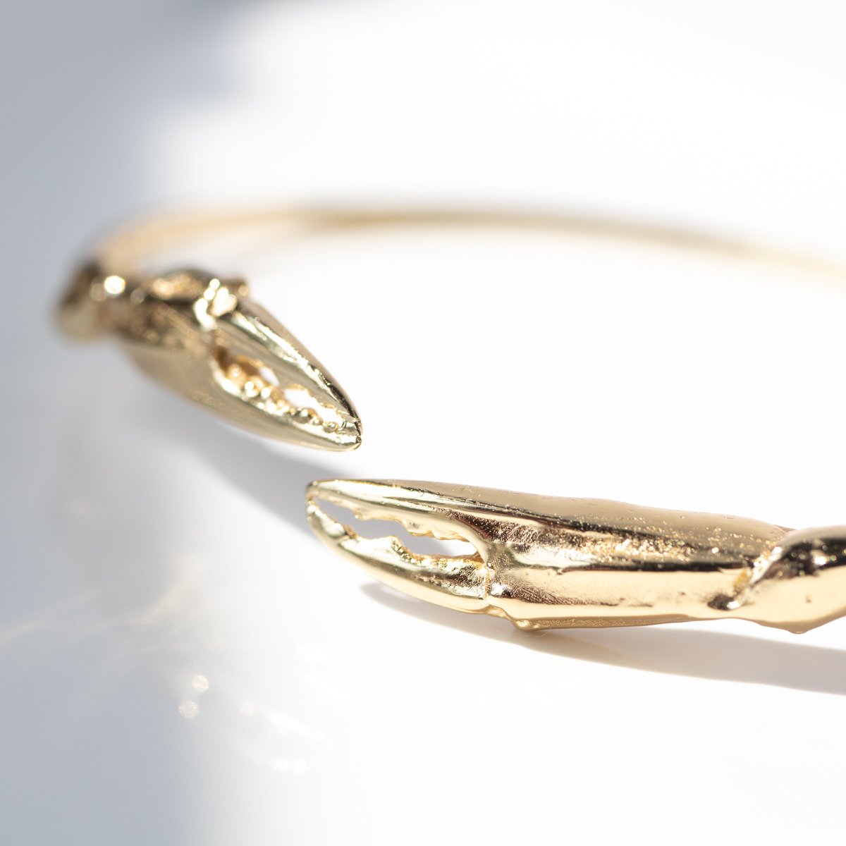 Crab claw cuff bracelet in gold by jewelry designer Lauren Newton