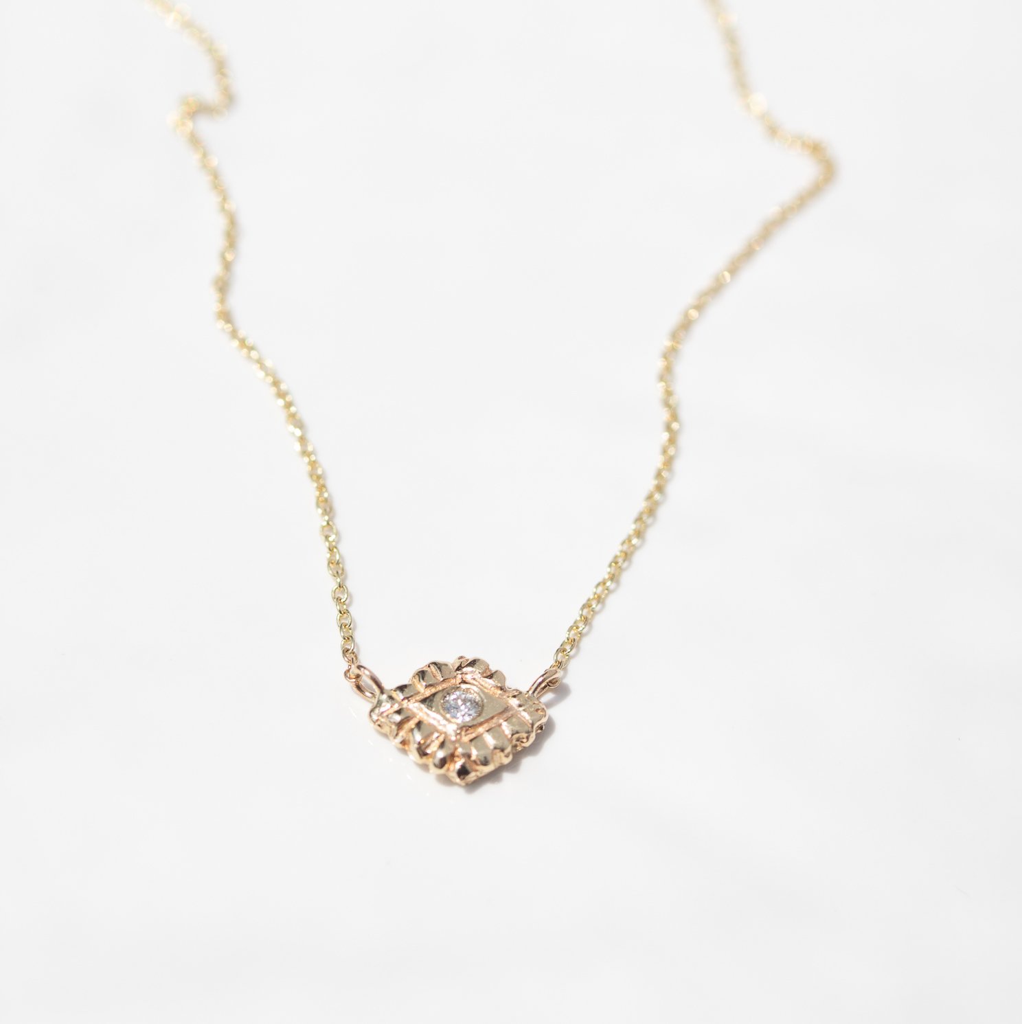 14k yellow gold and diamond Eye of Light necklace by jewelry designer Communion by Joy