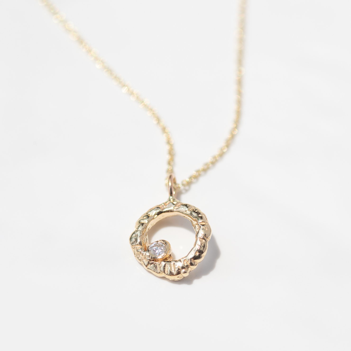 Circle of Love necklace in 14k yellow gold with a white diamond by jewelry designer Communion by Joy