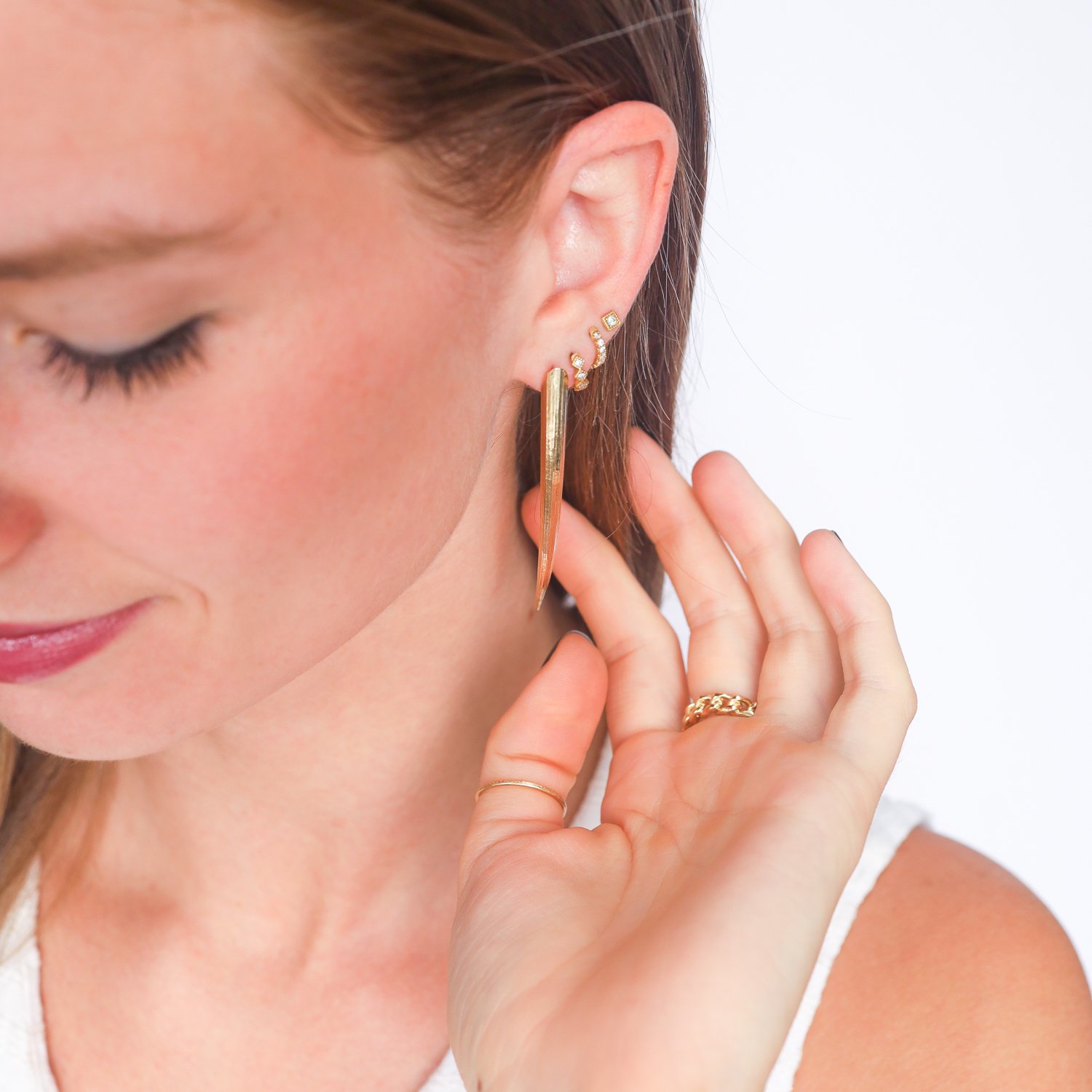 Gold tusk post earrings by jewelry designer Lauren Newton