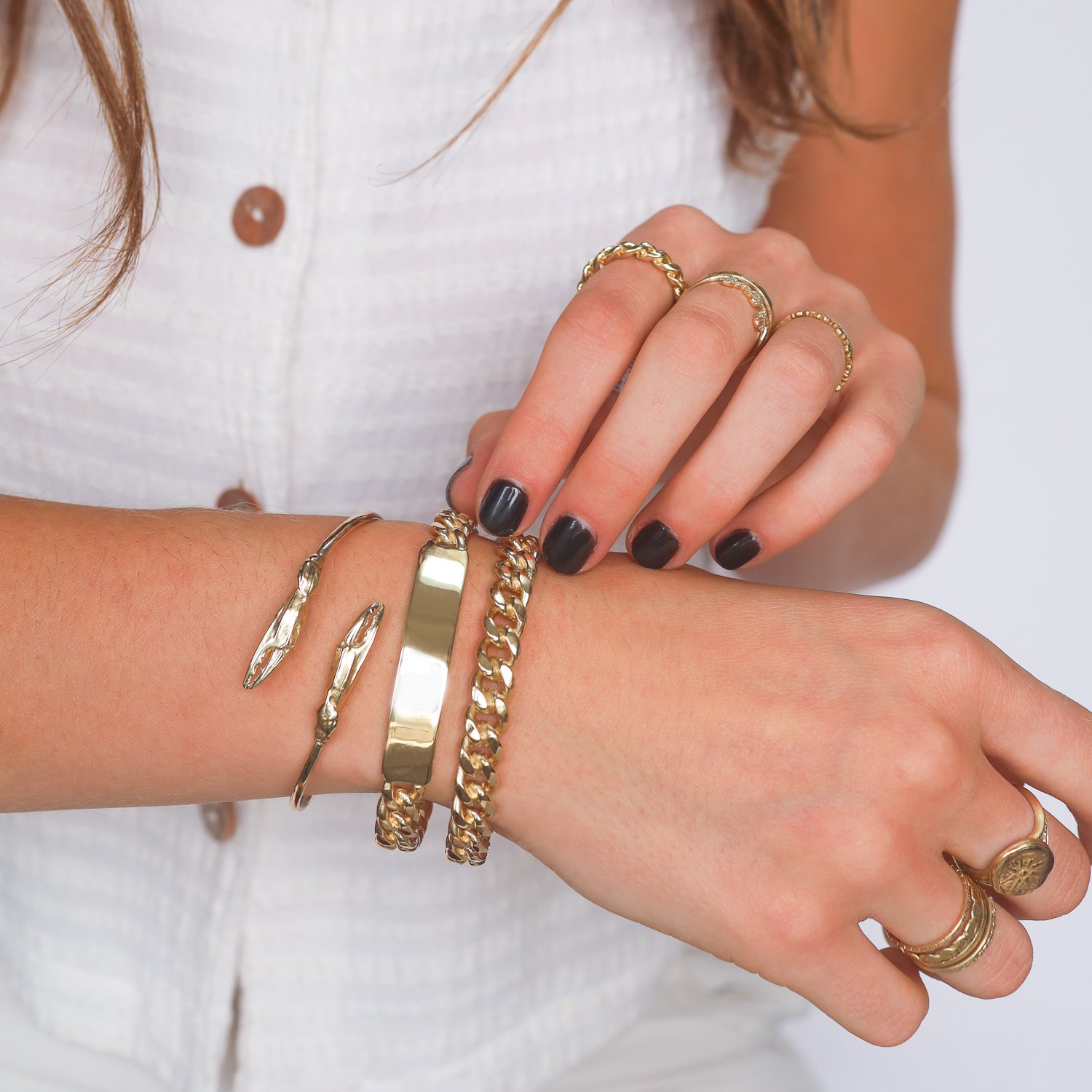 Chunky gold chain bracelets and cuffs by jewelry designer Lauren Newton