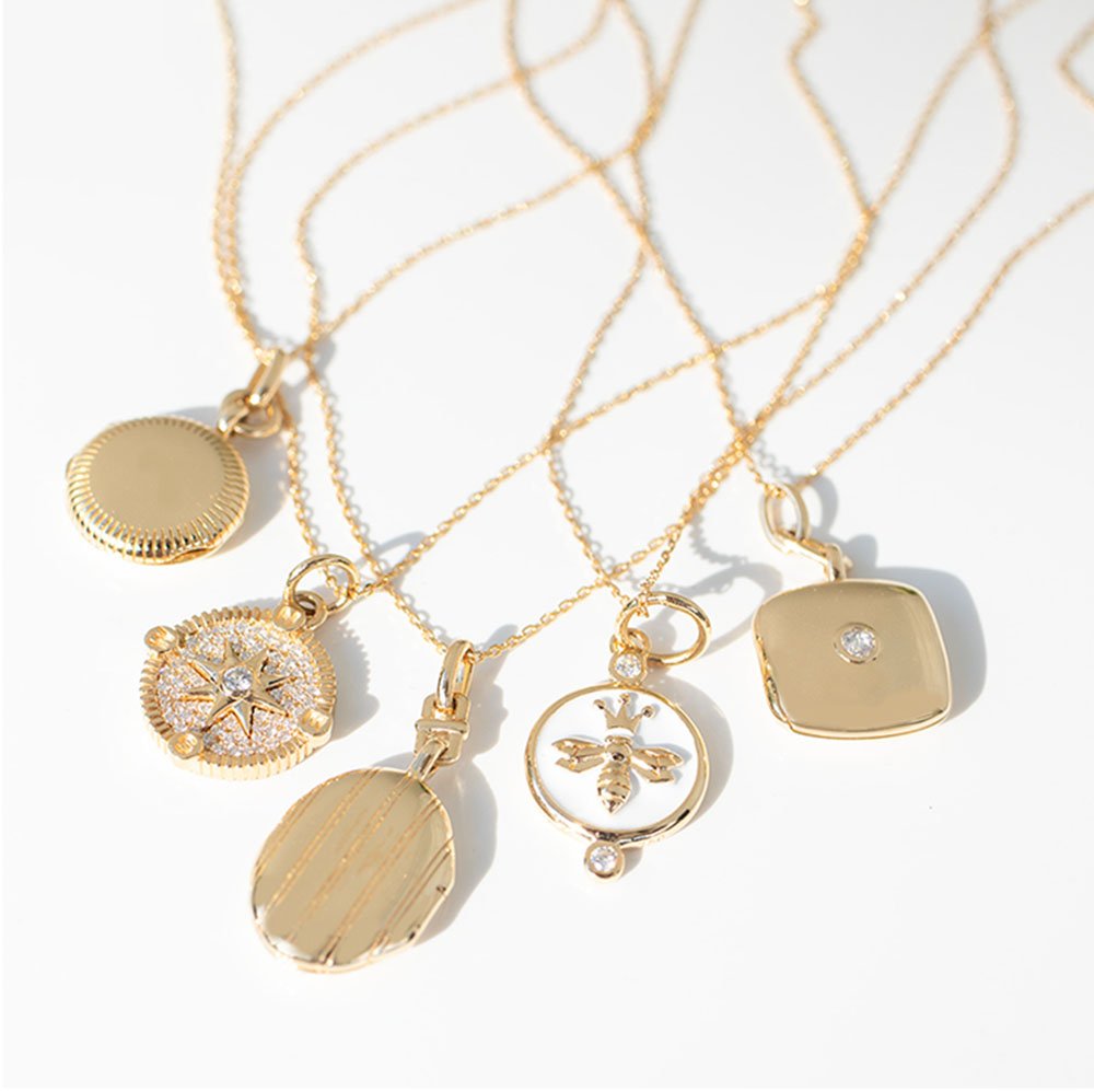 Gold necklaces and lockets by jewelry designer Monica Rich Kosann