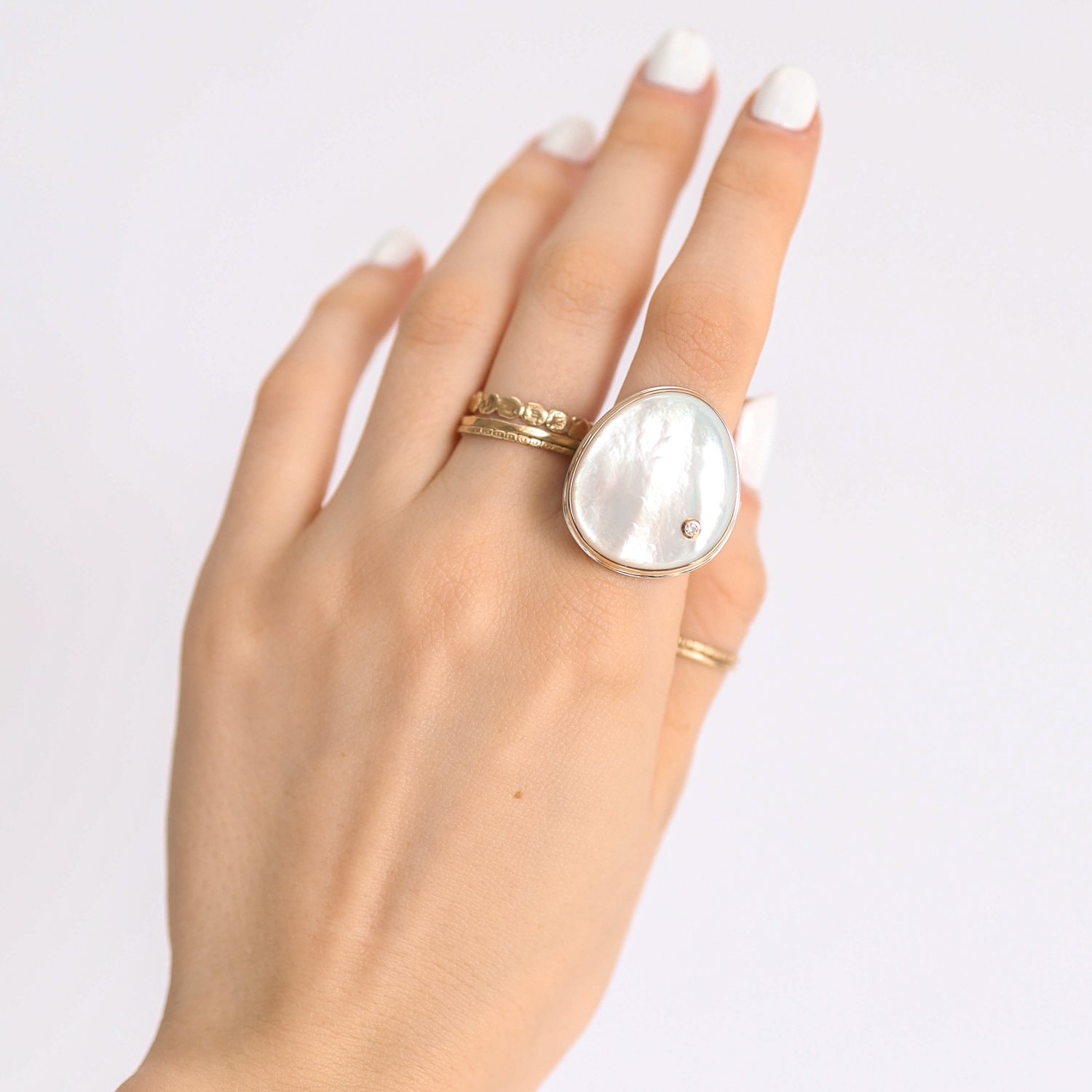 Jamie Joseph: Ring, Vertical asymmetrical smooth, 14K gold bezel set mother of pearl, Sterling silver live edge band, Stone measures 15/16 x 13/16, Currently available in size 7 1/2