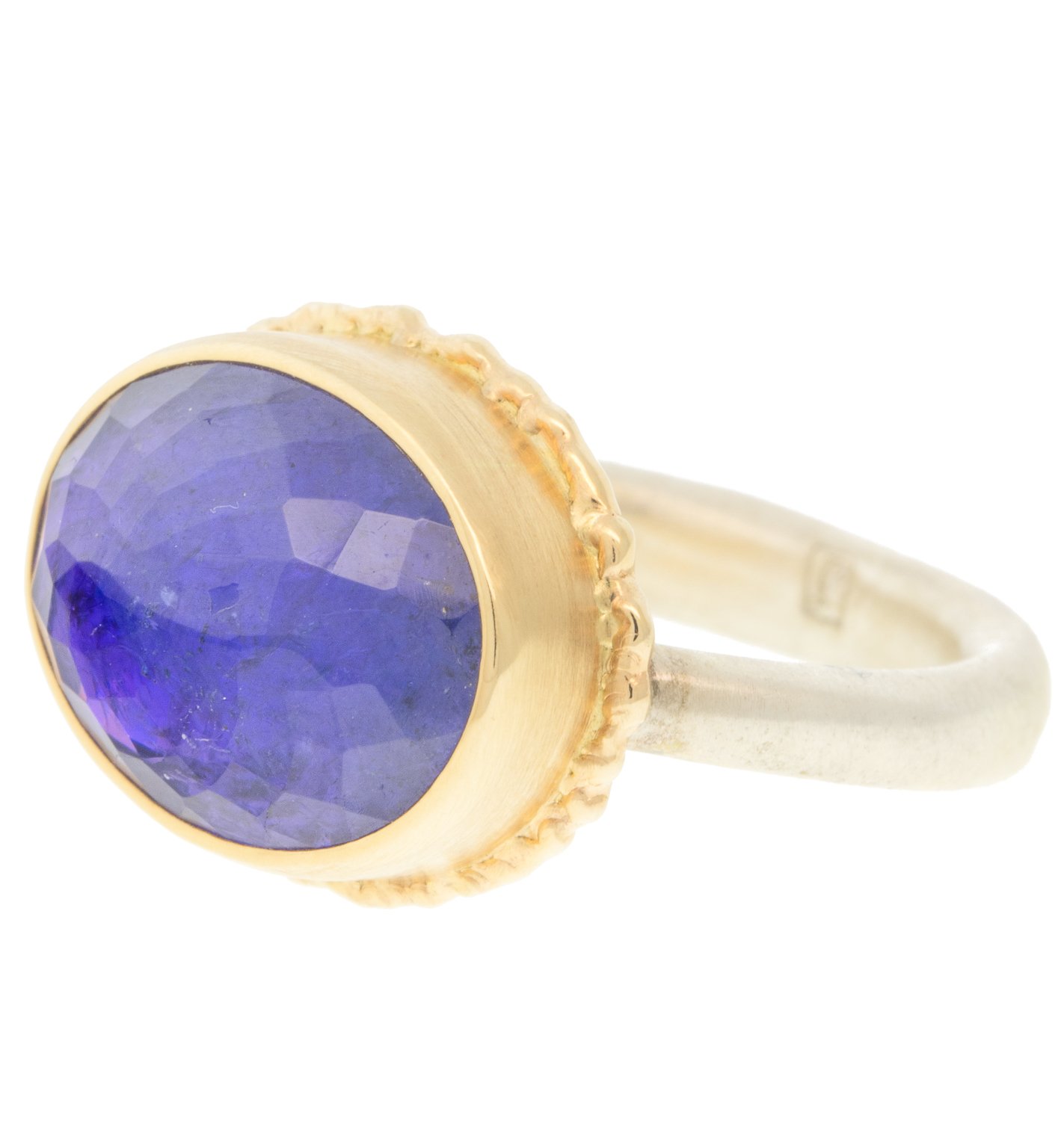 Jamie Joseph: Ring, Oval inverted, 14K yellow gold bezel set tanzanite on ruffled platform, Sterling silver Egyptian band, Stone measures 7/16 x 9/16, Currently available in size 6 3/4