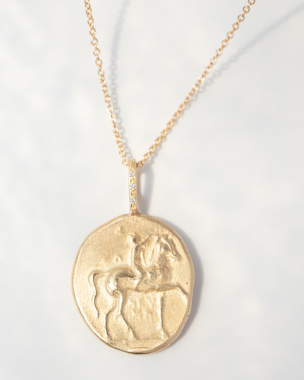 The Horse Artifact Necklace in 14k yellow gold by jewelry designer Robin Haley 