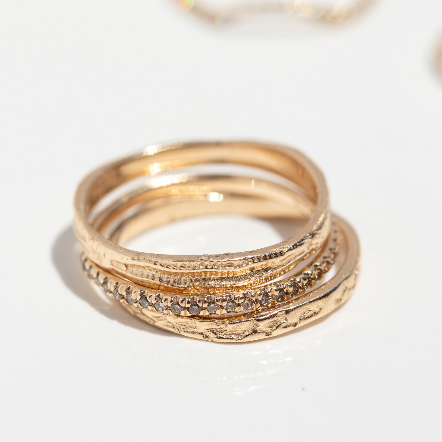 Rings and bands in 14k gold and sterling silver by jewelry designer Lauren Wolf