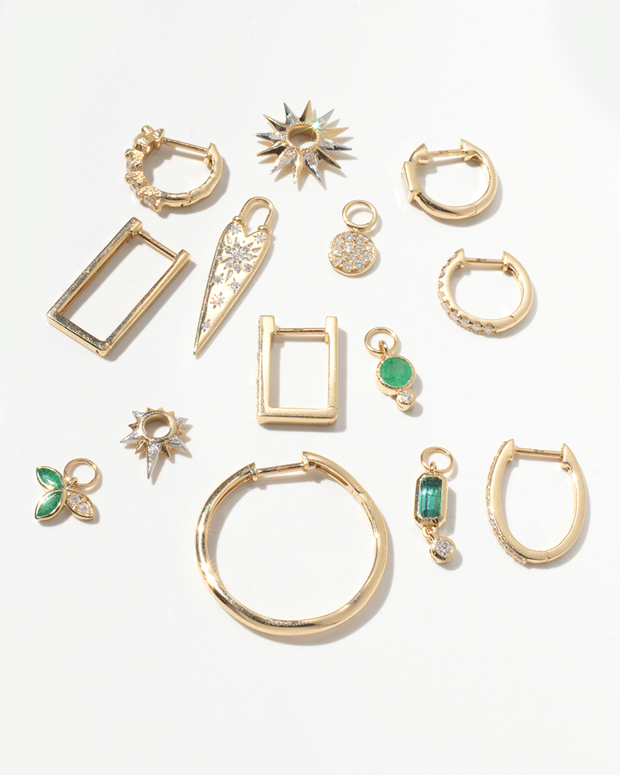 Earrings, charms, and hoops in 14k yellow gold and white diamonds by jewelry designer Three Stories