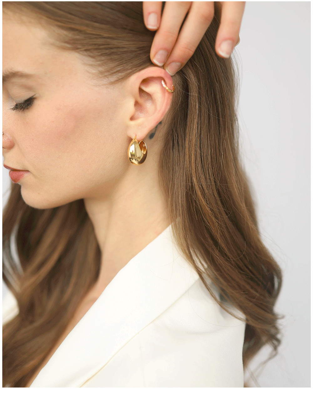 Gold hoop earrings, bracelets, and necklaces by jewelry designer Tai