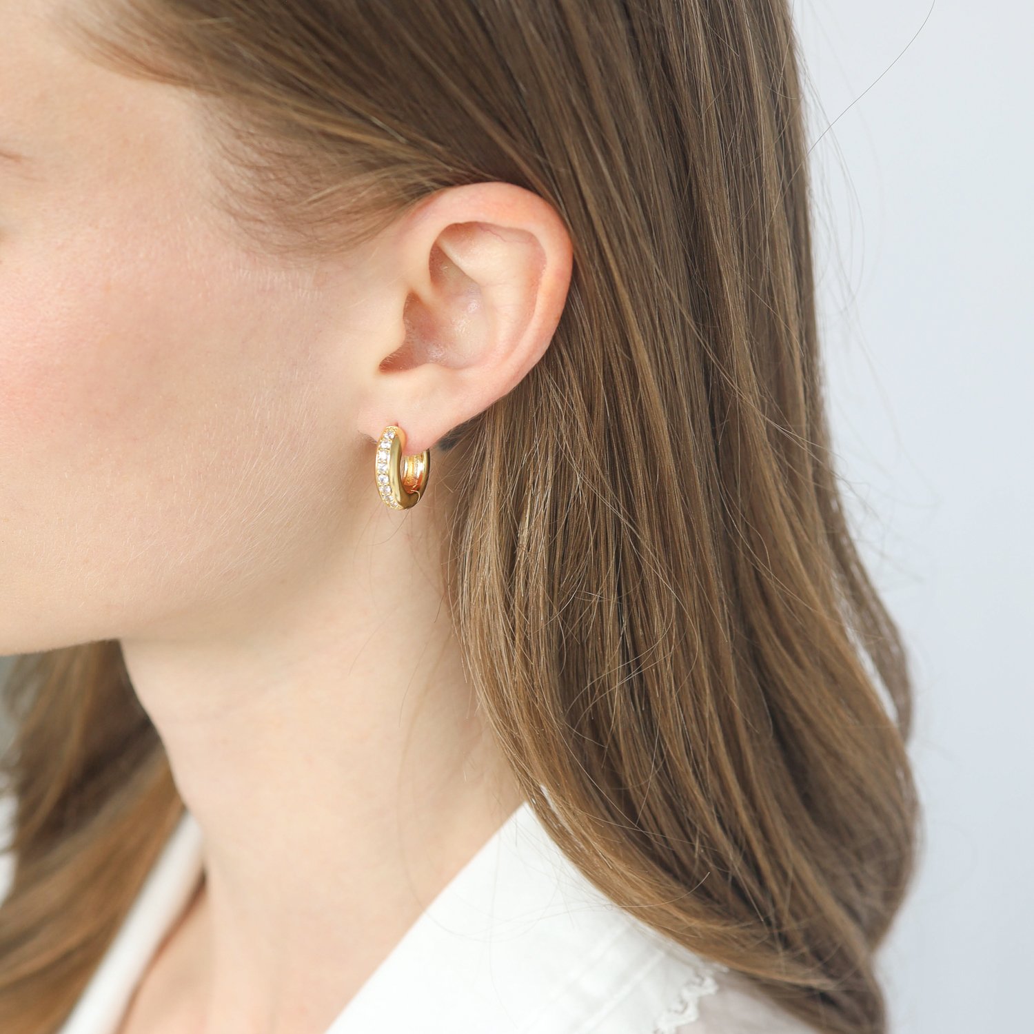 Tai: Gold Huggie Earrings with 1 Row of Set CZ, 5/8 in diameter 3/8 in width