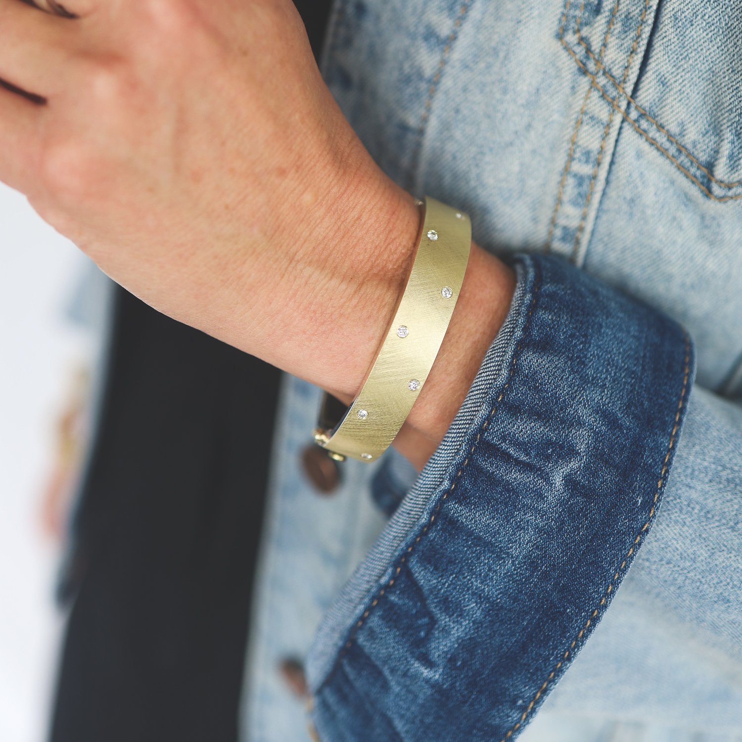 Rene Escobar: Bangle, NUBIA, 1/2 in width, 18K yellow gold front, Sterling silver back, 7 diamonds on front.