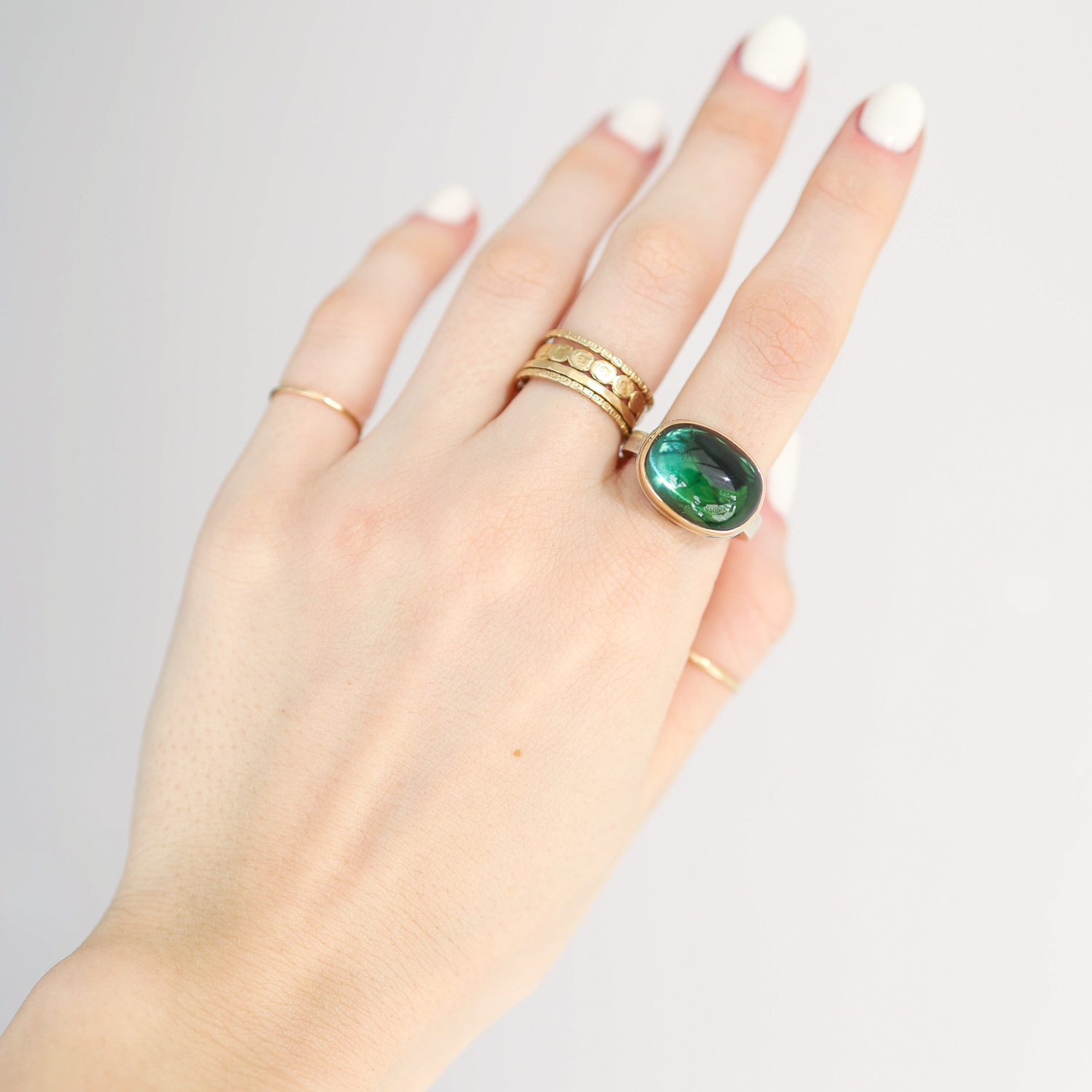 Jamie Joseph: Ring, Oval smooth, 14K gold bezel set blue green tourmaline, Sterling silver X band, Stone measures 1/2 x 5/8, Currently available in size 7 1/4