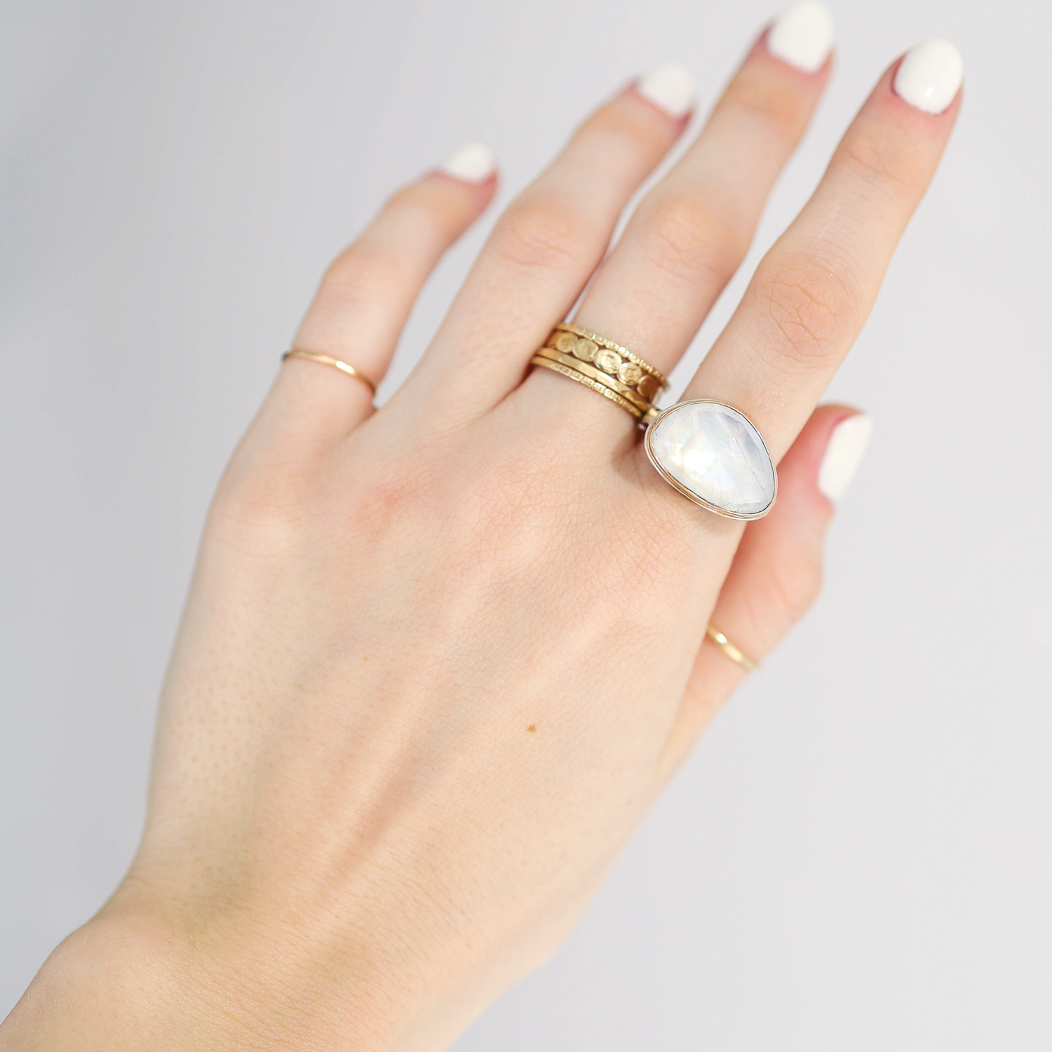 Jamie Joseph: Ring, Small asymmetrical rose cut, 14K gold bezel set white rainbow moonstone, Sterling silver eroded live edge band, Stone measures 7/16 x 11/16, Currently available in size 8