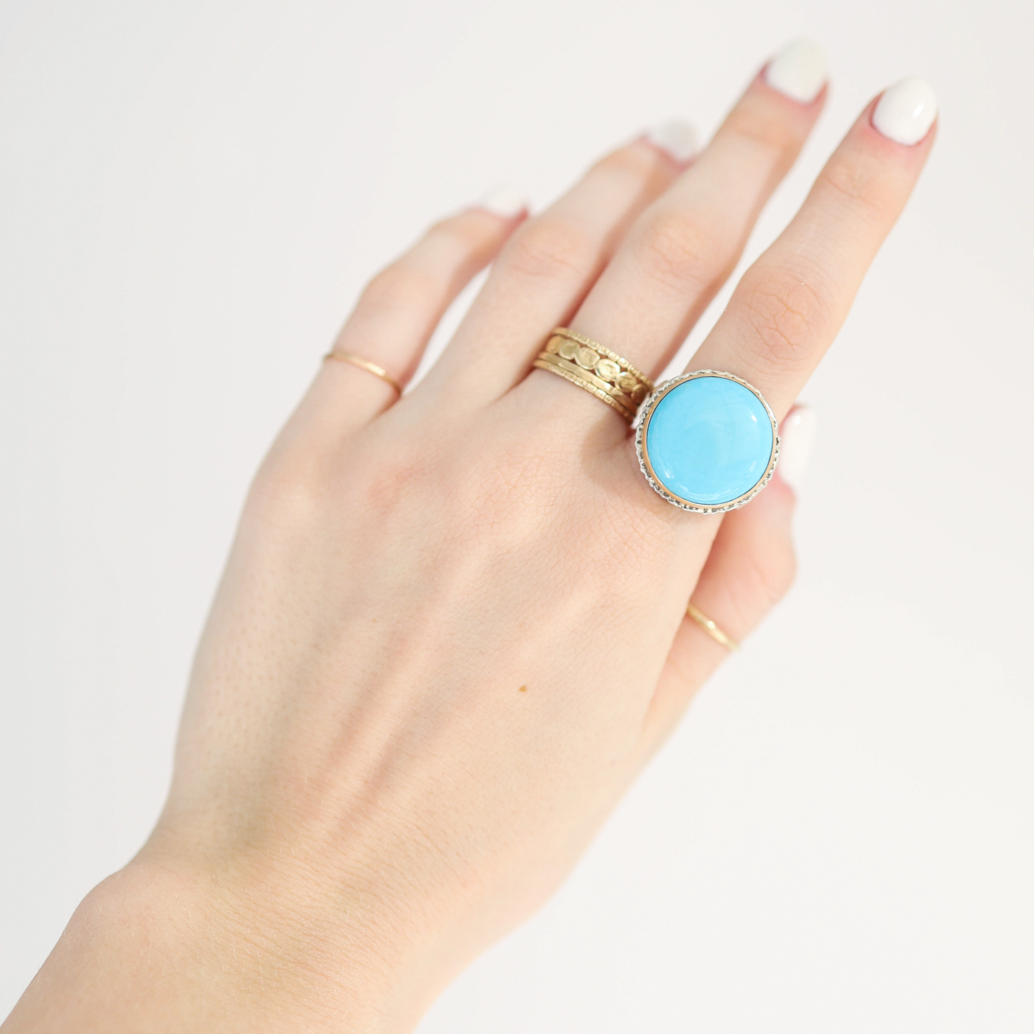 Jamie Joseph: Ring, Round smooth, 14K gold bezel set sleeping beauty turquoise on lava platform, Sterling silver soft live edge band, Stone measures 11/16 in diameter, Currently available in size 7 1/2