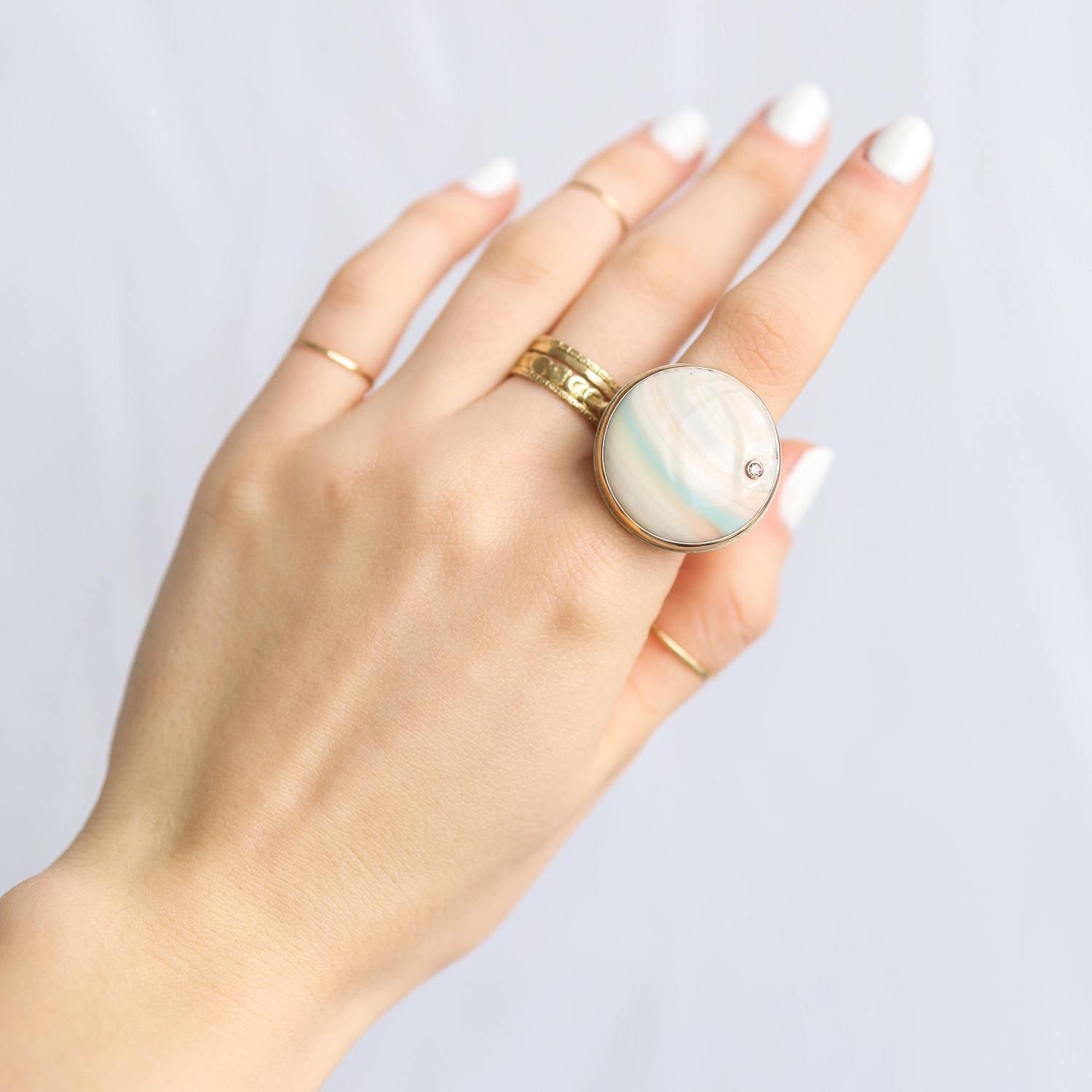 Jamie Joseph: Ring, Large round, 14K gold bezel set Saturn chalcedony, Diamond, .03ct, Sterling silver groovy band, Stone measures 1 in diameter, Currently available in size 7 3/4