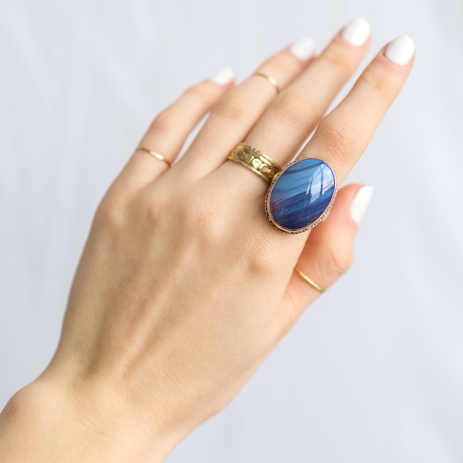 Jamie Joseph: Ring, Vertical oval, 14K rose gold bezel set Leland blue stone on lave platform, Sterling silver groovy band, Stone measures 13/16 x 5/8, Currently available in size 7 1/2