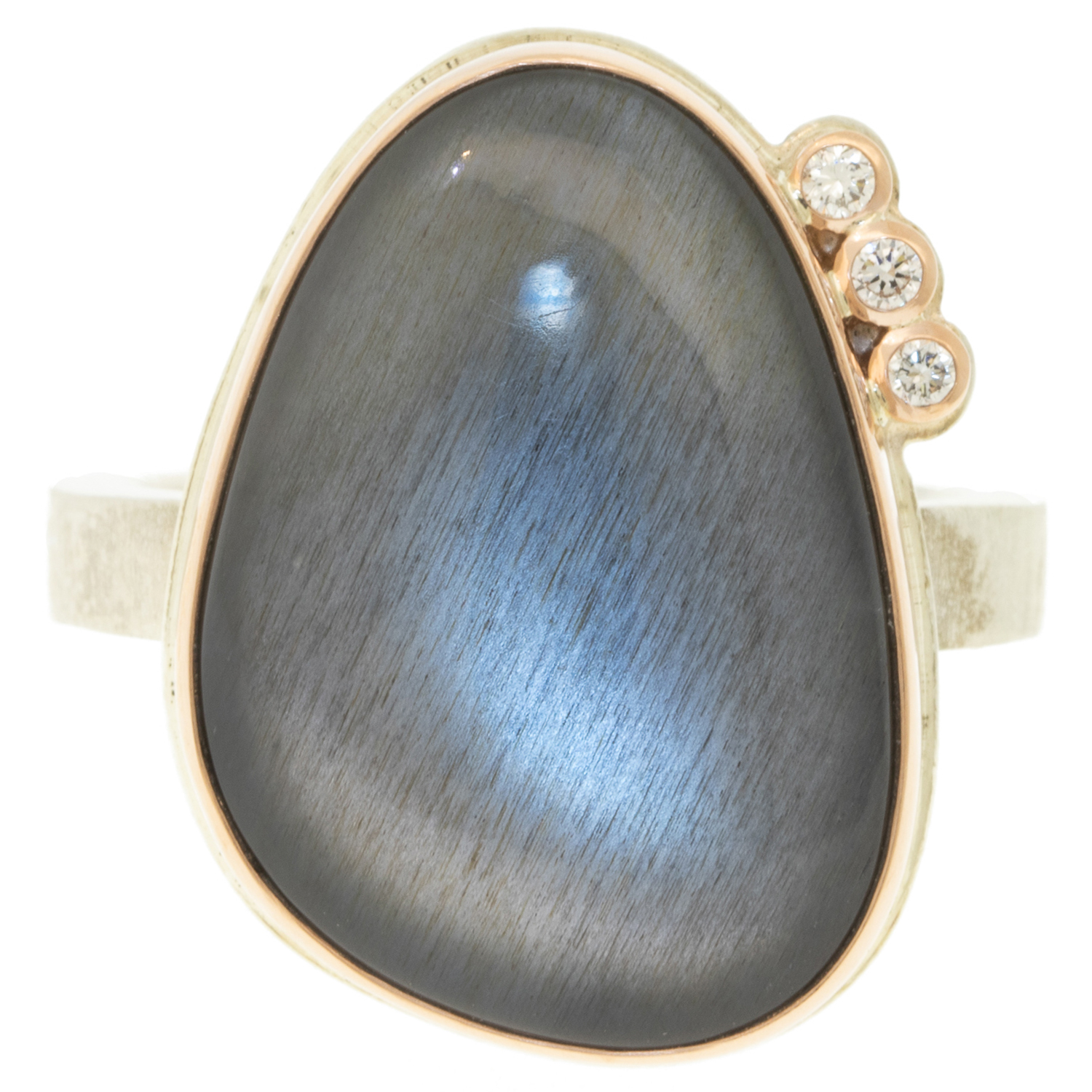 Jamie Joseph: Ring, Vertical asymmetrical smooth, 14K rose gold bezel set grey moonstone, Satellite diamond, .025ct, Sterling silver soft live edge band, Stone measures 13/16 x 9/16, Currently available in size 7 1/4