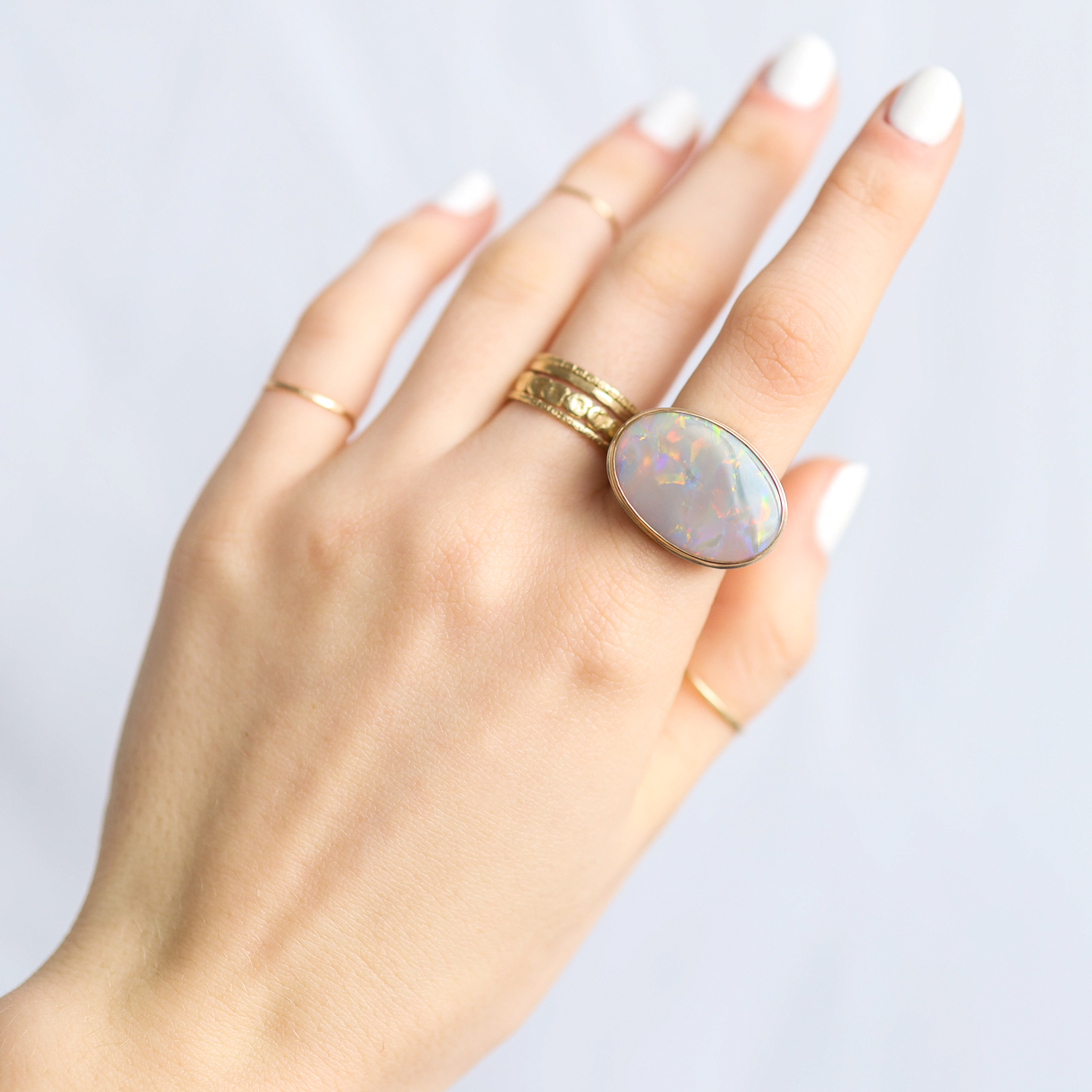 Jamie Joseph: Ring, Oval, 14K gold bezel set Australian black opal on open back platform, Sterling silver middle groovy band, Stone measures 5/8 x 7/8, Currently available in size 7 1/2