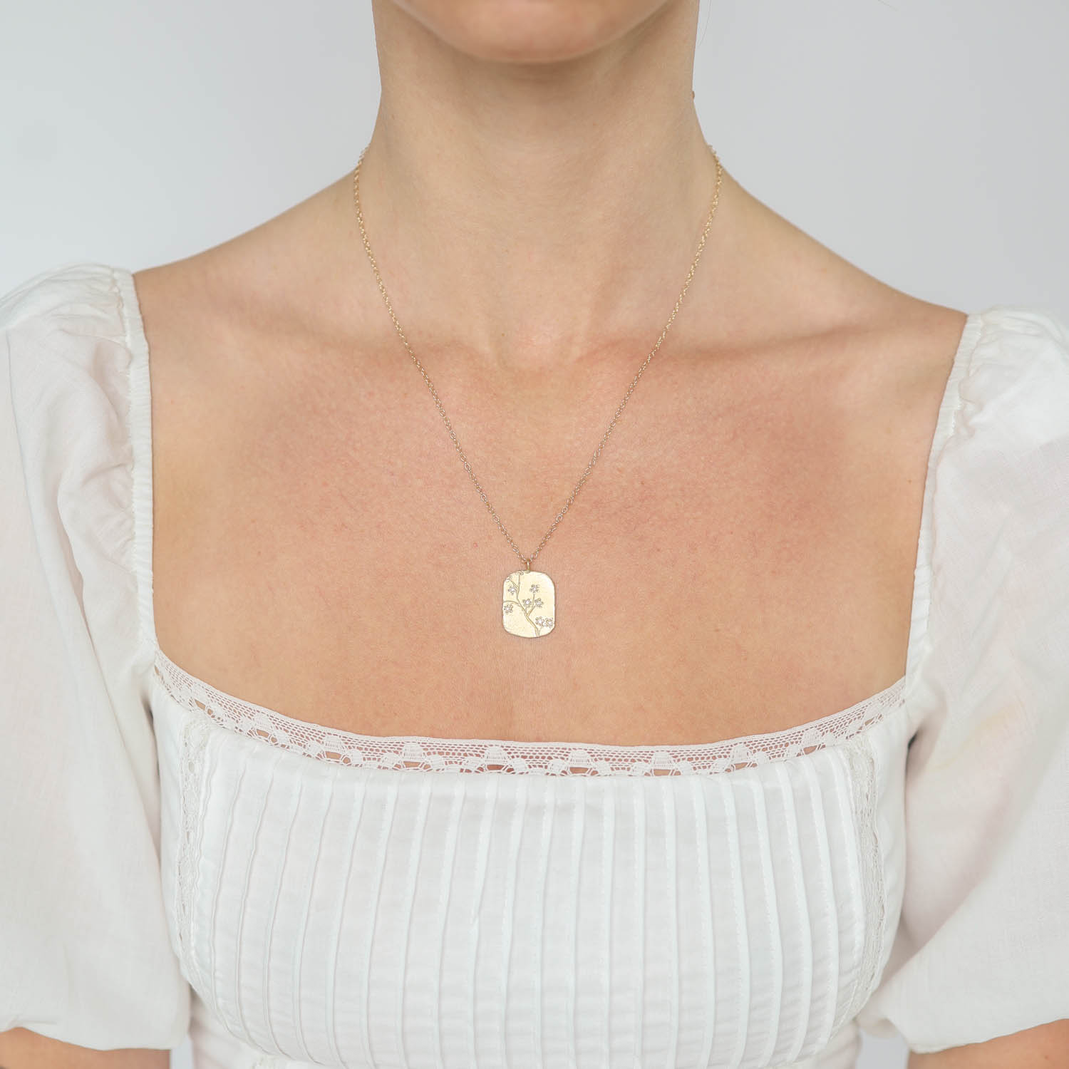 Victoria Cunningham Trunk Show: 14K lg cherry blossom dog tag- 18" in length 15/16" x 5/8" inc bail