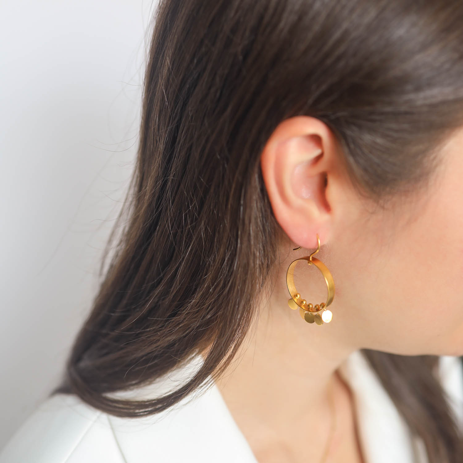 Jane Diaz: Circle mobile with spinning disc drops- gold plate, measures 1 5/8" x 1" including earwire