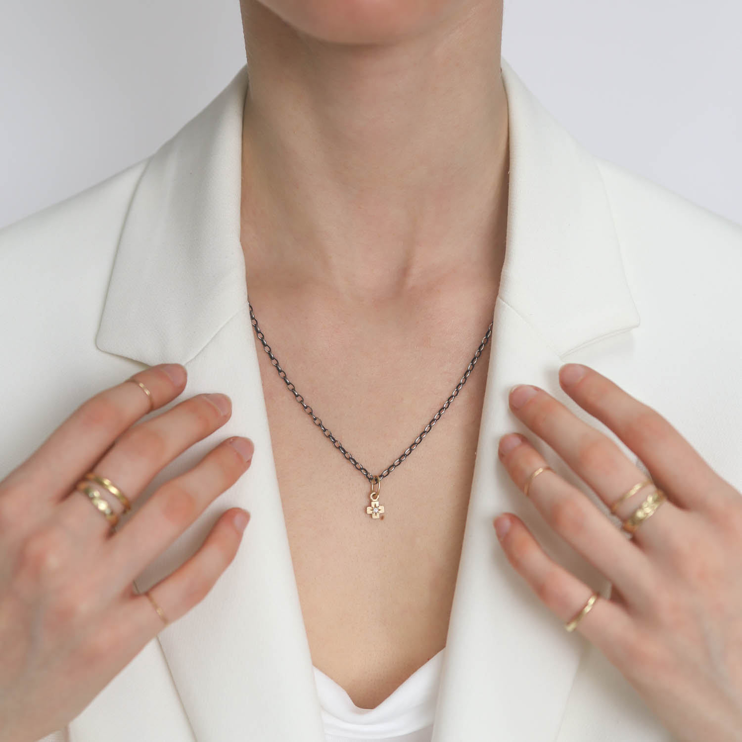 Erica Molinari Trunk Show: 14k single diamond baby cross .025cts