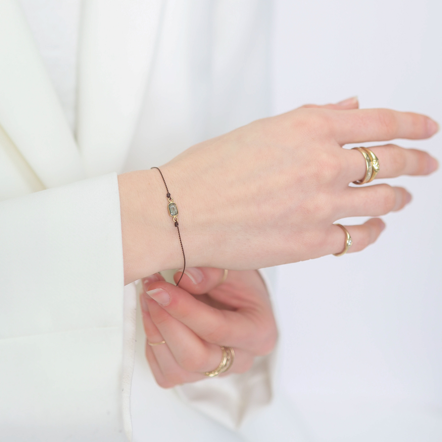 Margaret Solow:Bracelet on cord,18K Green Sapphire