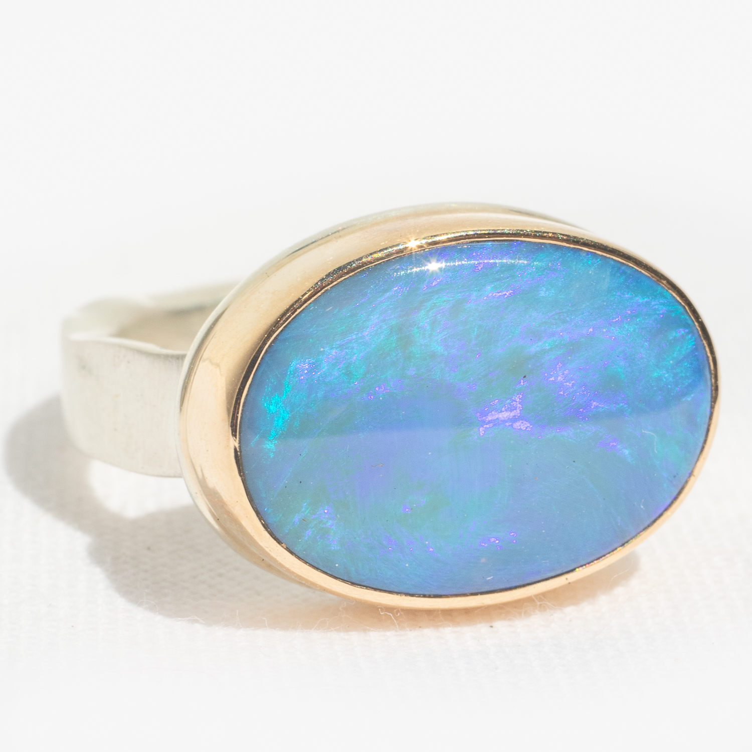 Gold and silver ring with Australian black opal by jewelry designer Jamie Joseph