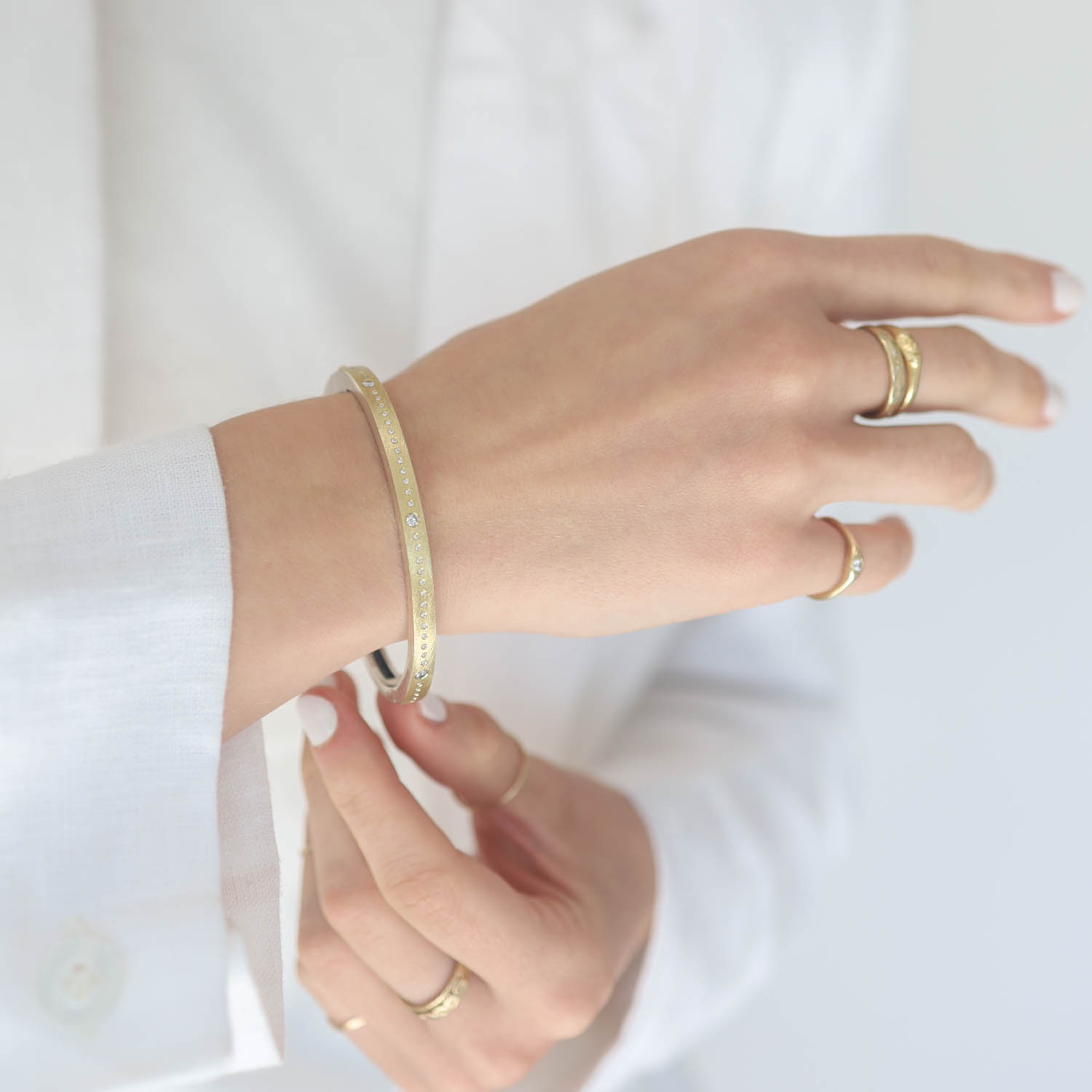 Rene Escobar: Bangle, MERIDIAN, 4mm in width, Yellow Gold front, Oxidized sterling silver back, Diamonds, Size medium.