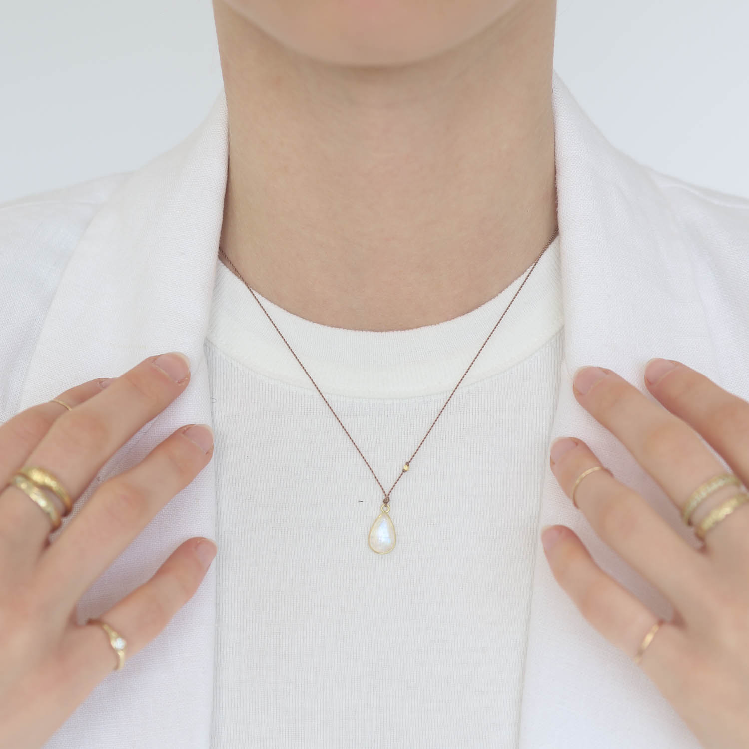 Margaret Solow: Necklace, Cabochon moonstone, 18K yellow gold, Nylon cord