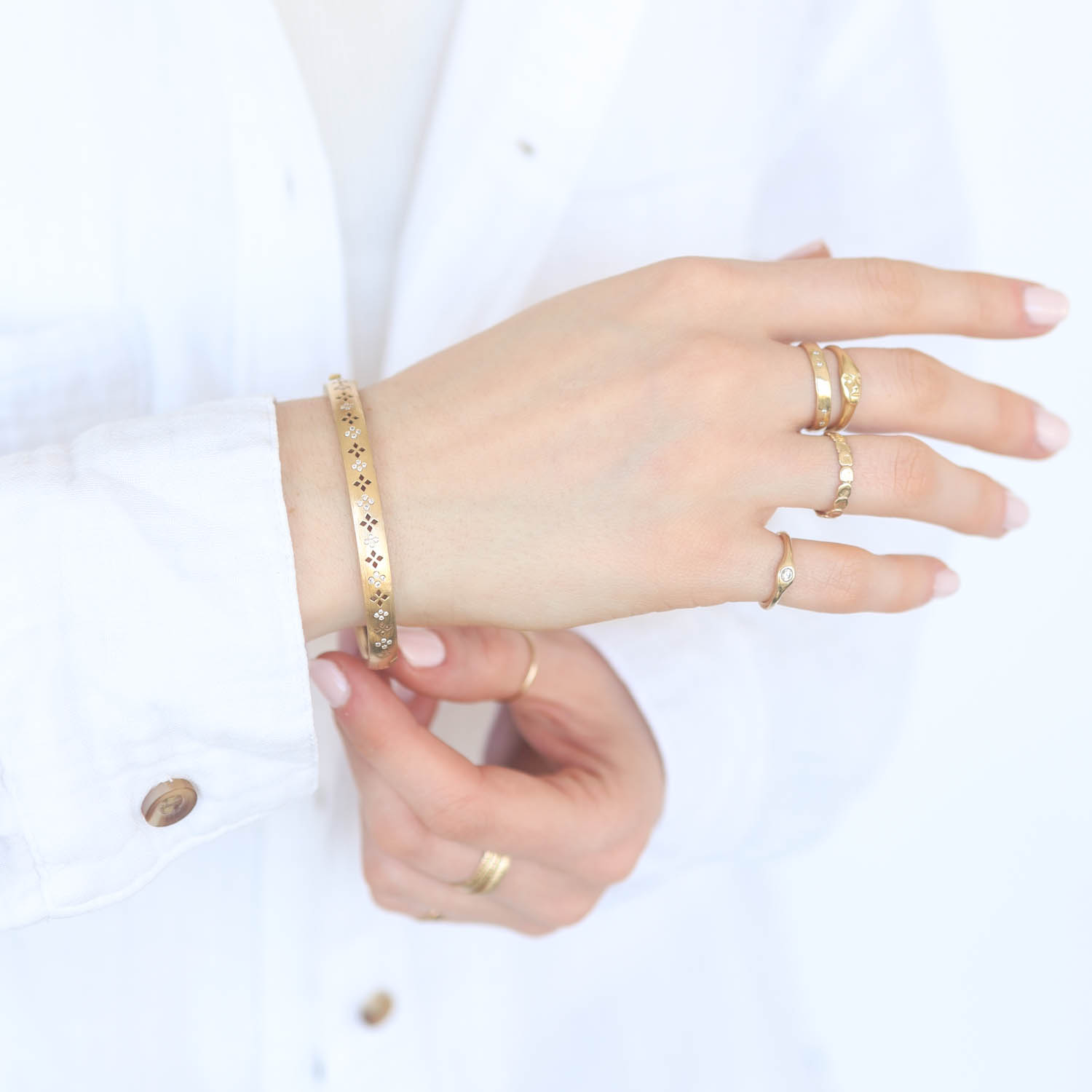 Erica Molinari Trunk Show: 18K craved Clover pattern set with diamonds on 1 side- .20cts, measures 1/4" in width