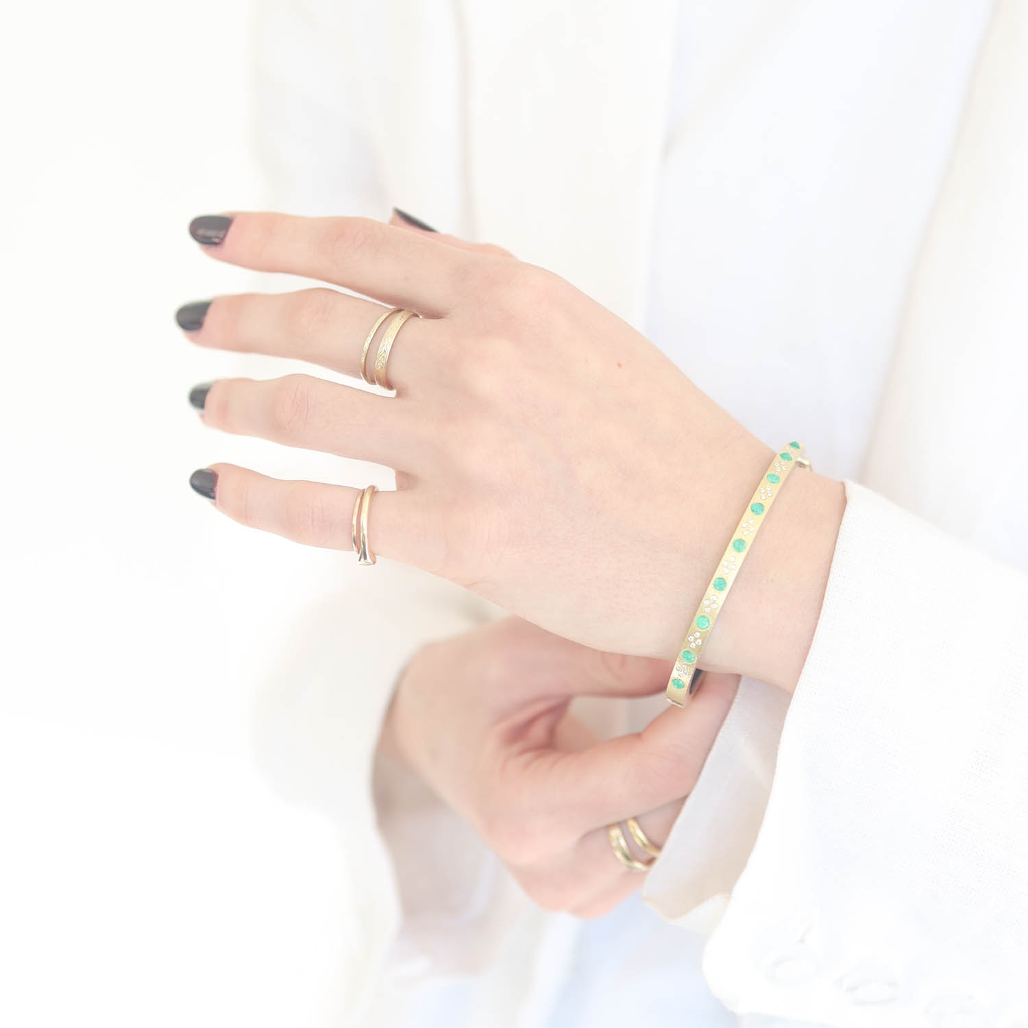 Rene Escobar Trunk Show:#11 4MM. SS hinged bangle featuring an 18k YG push button style clasp and a solid 18k YG top sheet set with CAB cut 1.25CT of EME.