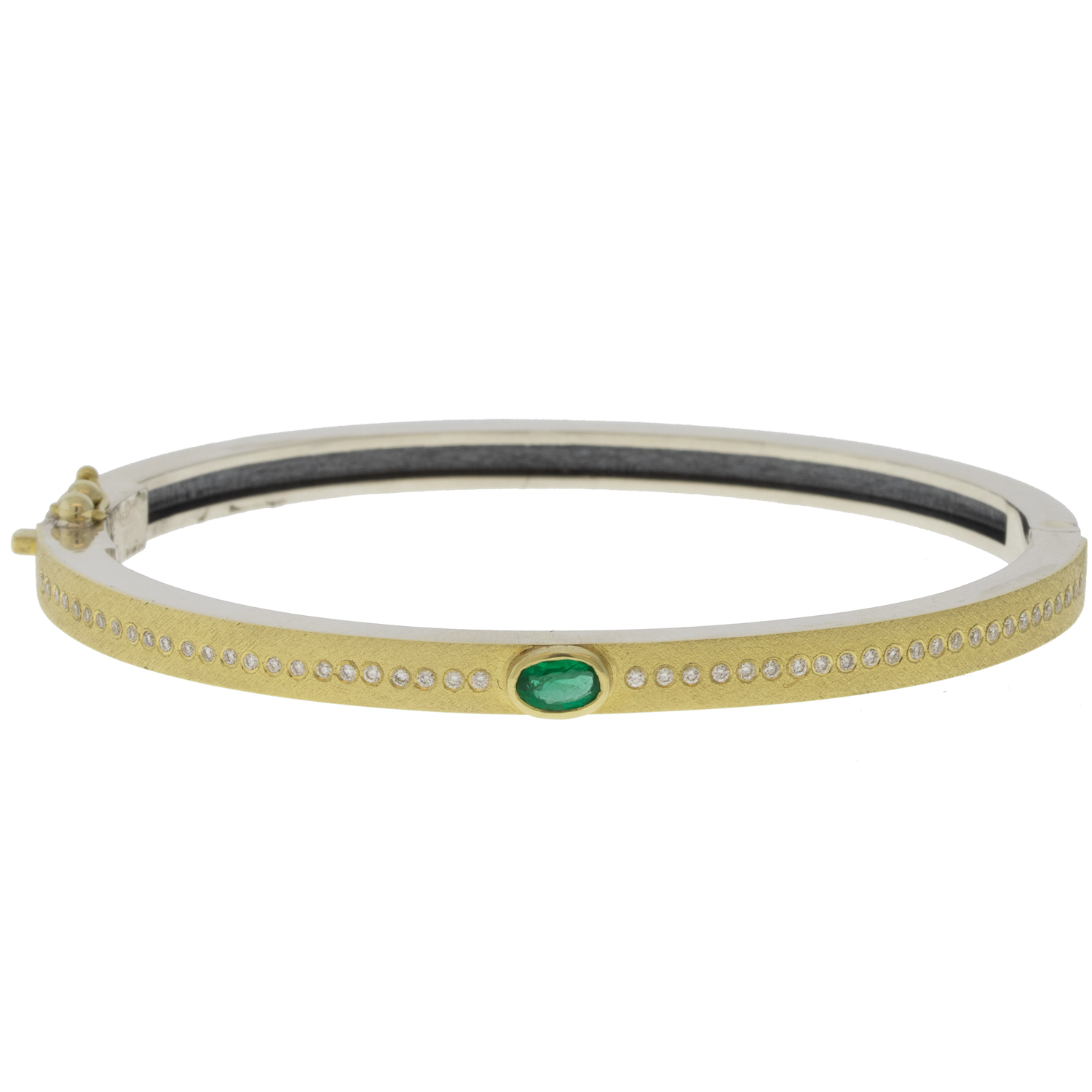 Rene Escobar:JUNIA PLUS 4MM YG hinged bangle featuring an 18k YG push button style clasp and a solid 18k YG top sheet and bezel set with OV cut with 0.48CT of EME