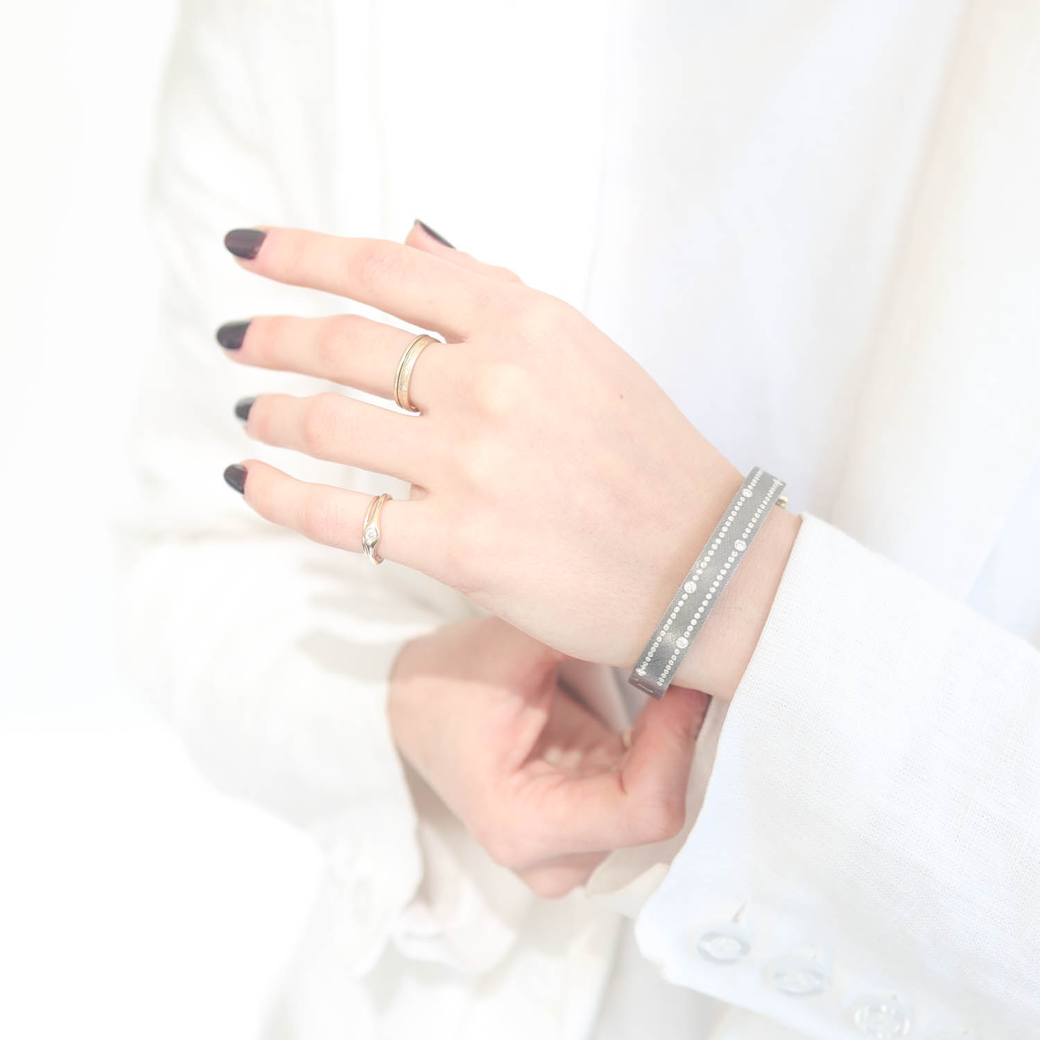 Rene Escobar Trunk Show:#42 8MM. SS hinged bangle featuring an 18k YG push button style clasp set with 0.80CT of WH diamonds