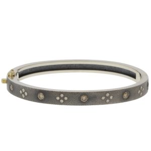 Rene Escobar:SHAYNA 6MM. SS hinged bangle featuring an 18k YG push button style clasp set with 0.58CT in CH & WH diamonds.