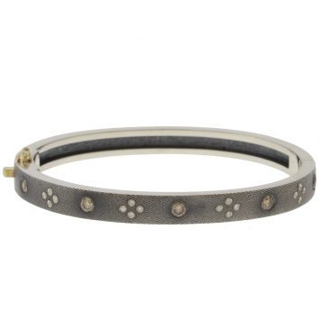 Rene Escobar:SHAYNA 6MM. SS hinged bangle featuring an 18k YG push button style clasp set with 0.58CT in CH & WH diamonds.