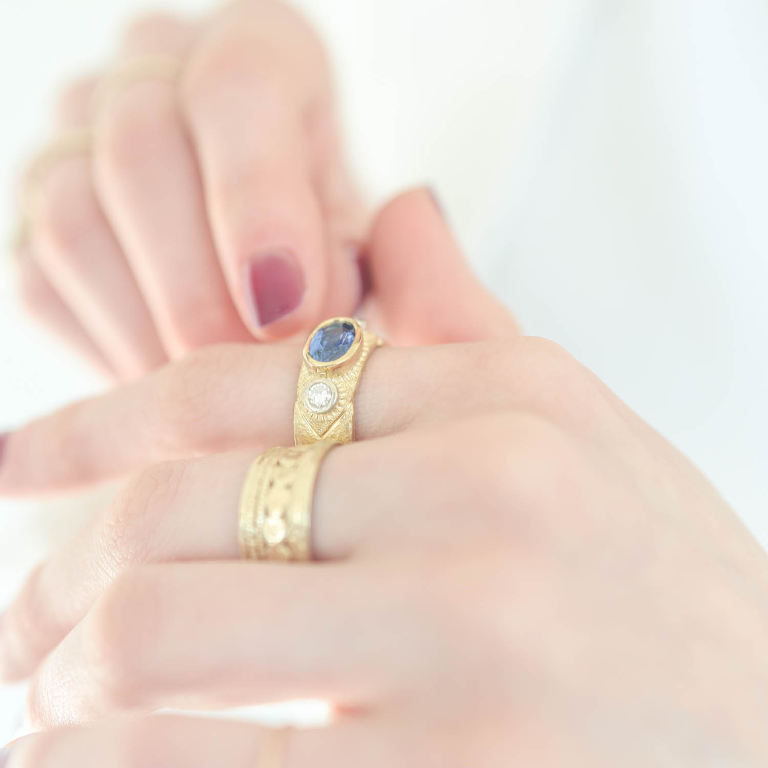 Alison Shiboski:18k Yellow gold ring with 1.75cts blue sapphire,2 diamonds 0.24ct in 14k white bezels