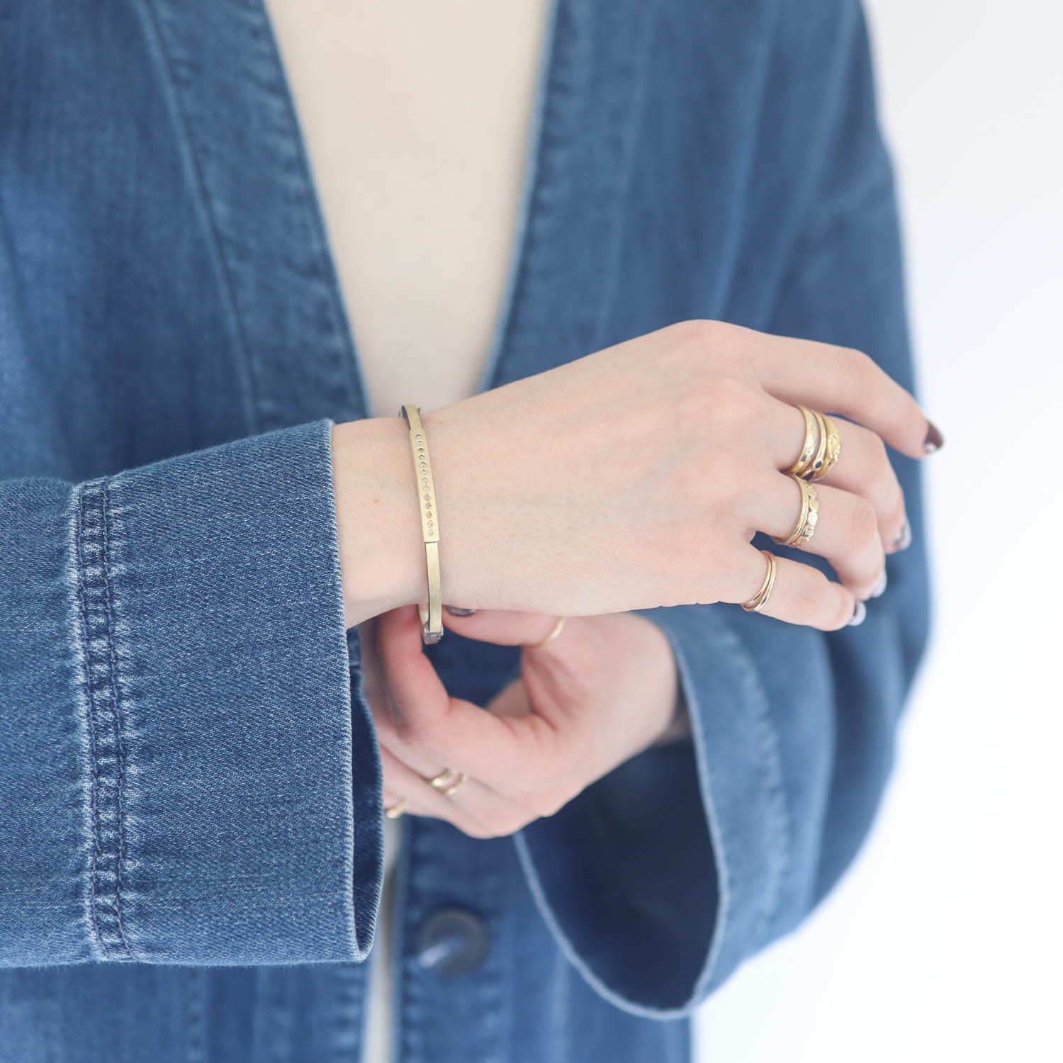 Rene Escobar: DIANA LUX 2.5MM SS hinged bangle featuring an 18k YG push button style clasp and 18k YG top sheet set with 0.40CT Champagne Diamonds