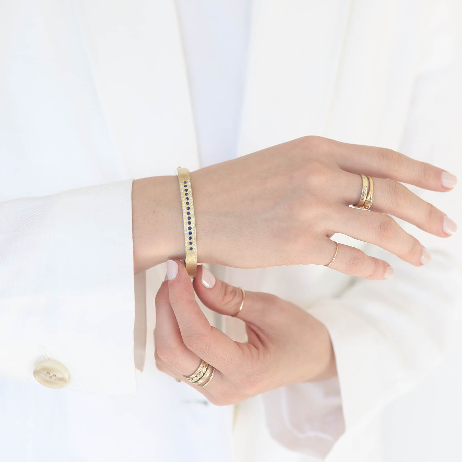 Rene Escobar Trunk Show: 29 6MM BANGLE WITH GOLD FRONT AND SILVER BACK SET WITH 0.0.75CT IN THREE ROWS OF SAPPHIRES AND WHITE DIAMONDS